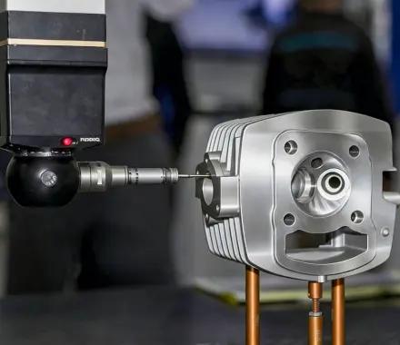 Metal welding quality control — CMM probe inspecting complex metal part
