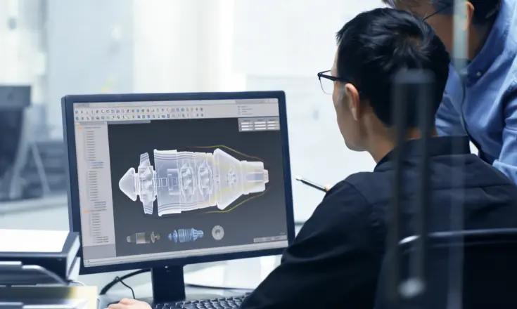 Engineer working with CAD design on computer for component adaptation