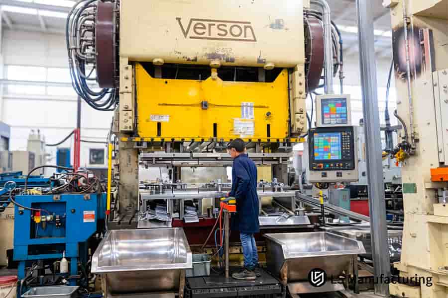 A worker stamps 6061 aluminum frame brackets for automotive assembly in a high-volume stamping service.