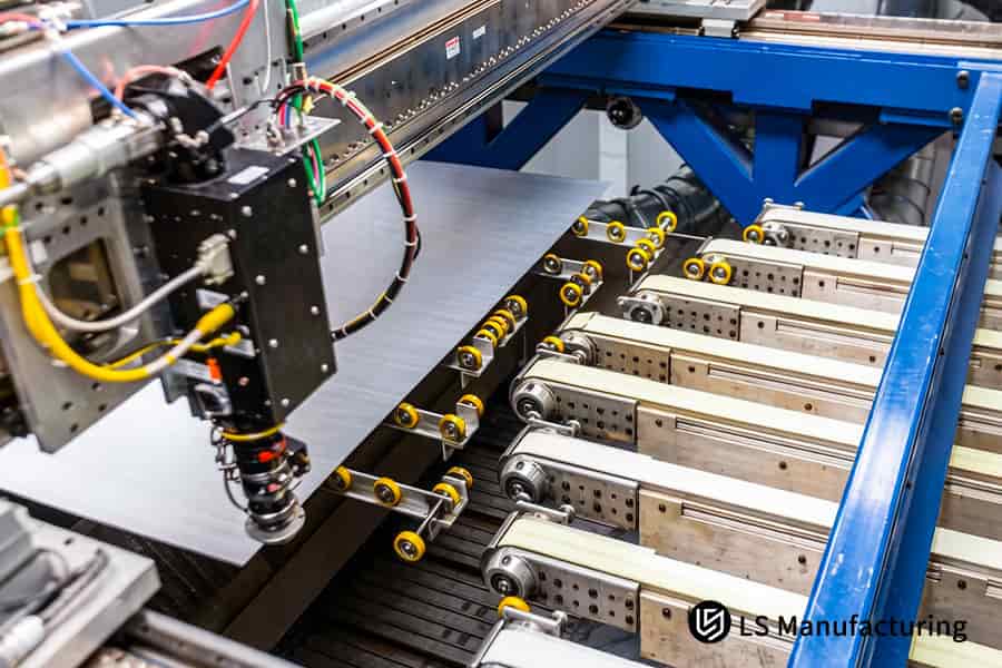 The robotic arm precisely picks up blanked 430 stainless steel blanks from the conveyor for appliance production.